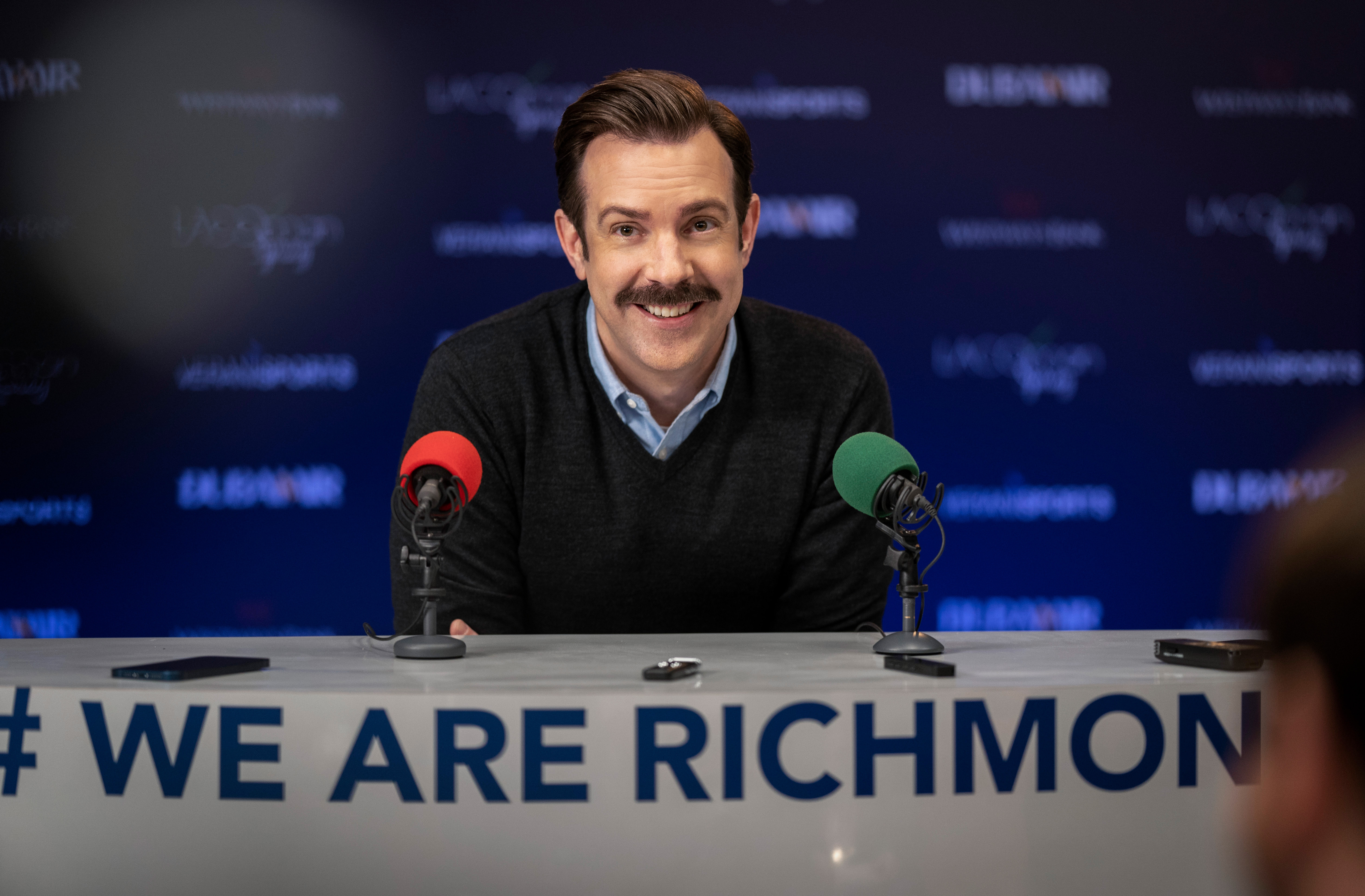 Jason Sudeikis smiling at a press conference