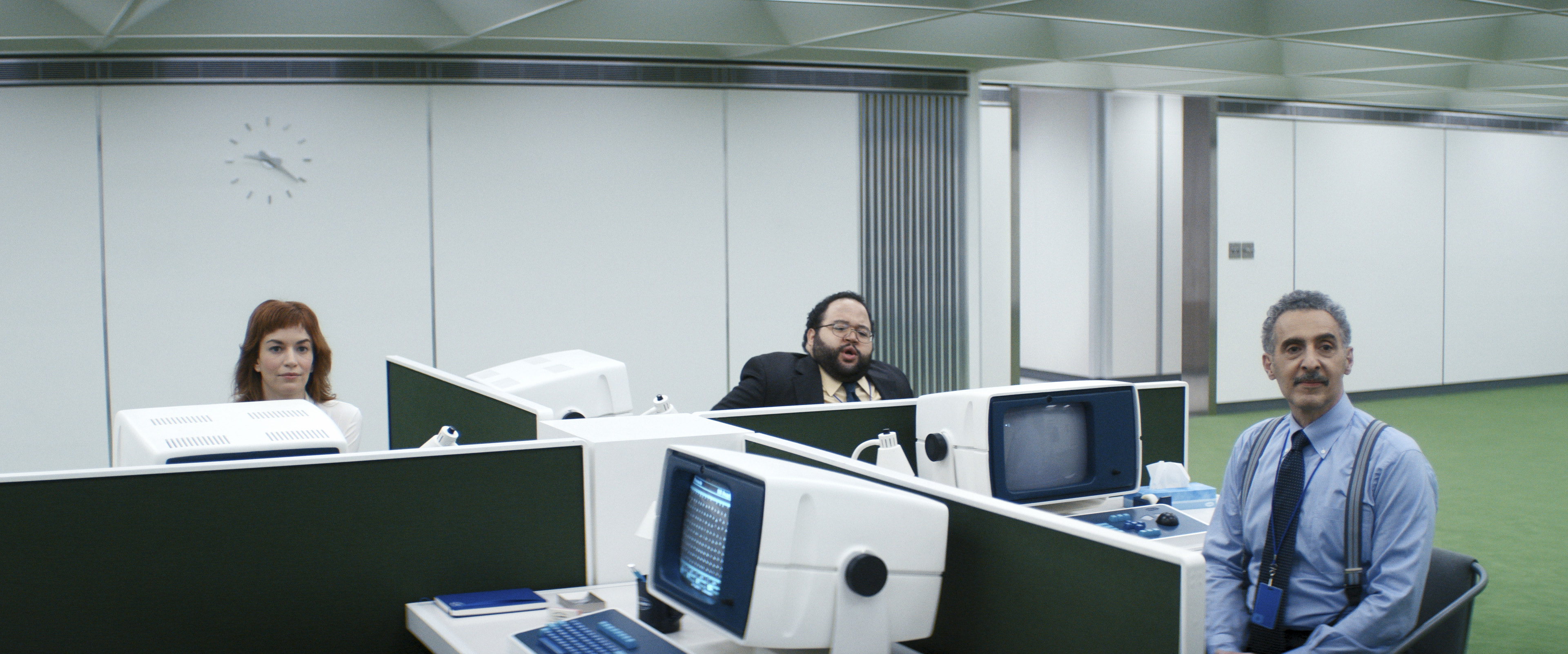 Britt Lower, Zach Cherry, and John Turturro at office cubicles