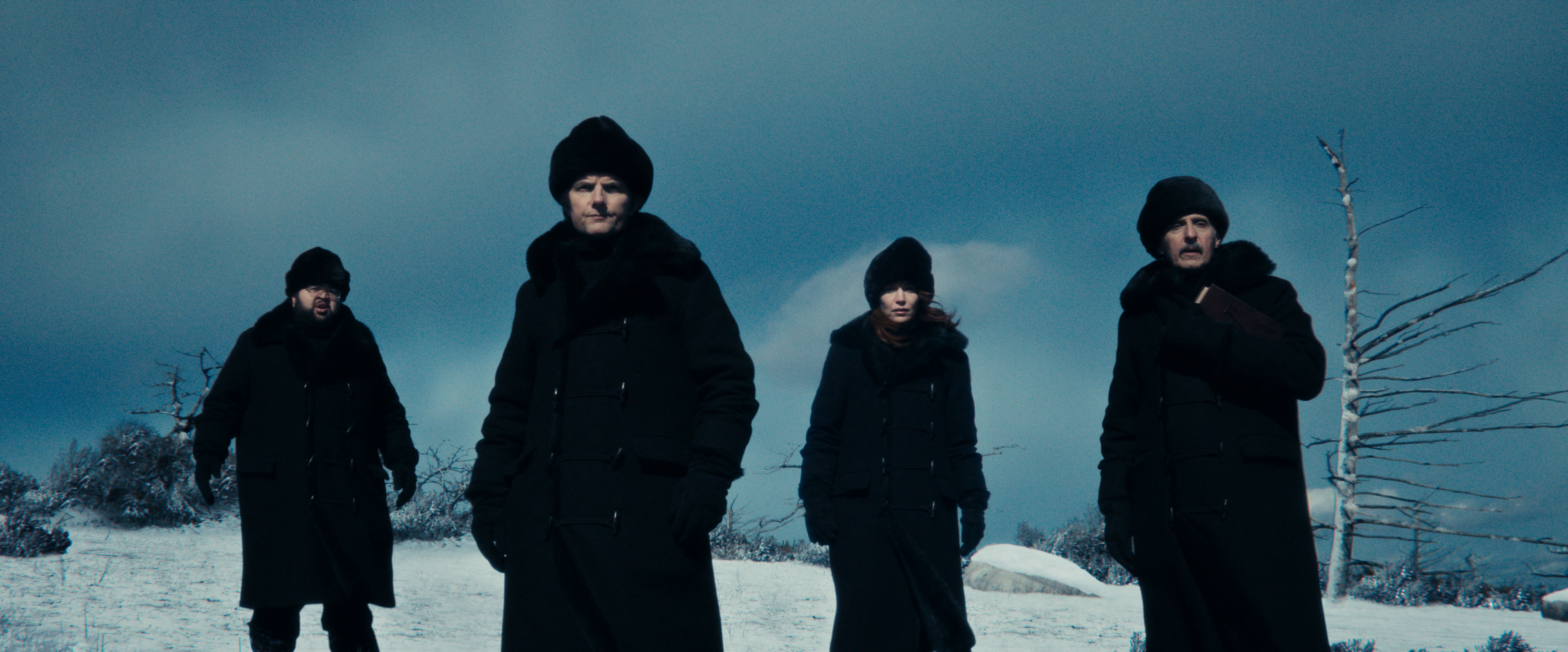 Main characters in black coats and hats